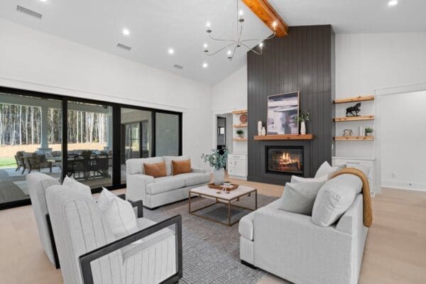 Modern living room with neutral tones and a fireplace.
