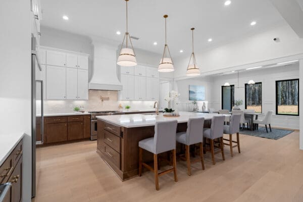 Modern kitchen with large island and pendant lights.