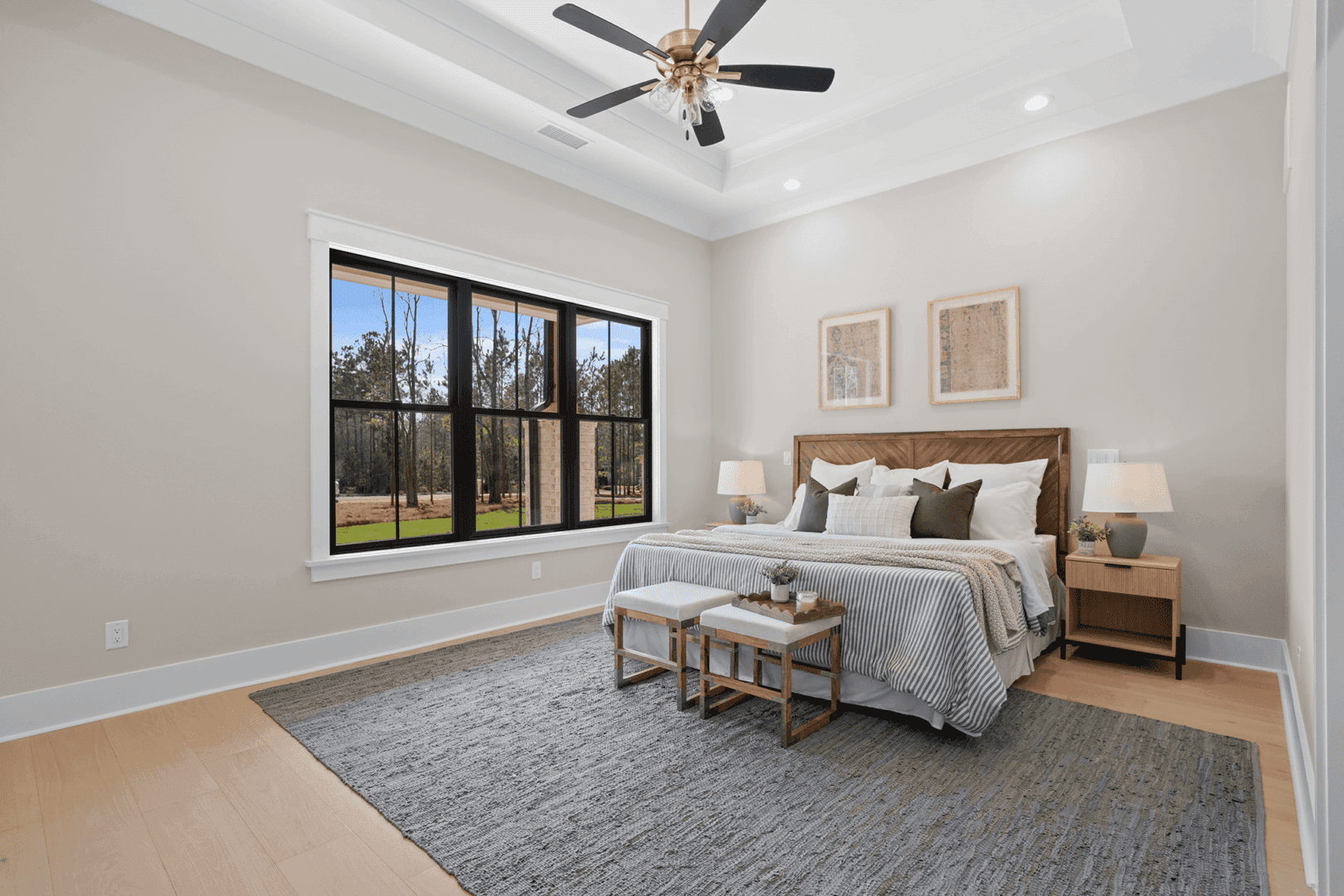 Bright bedroom with large window and cozy bedding.