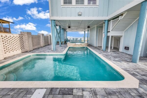 Modern outdoor pool with clear water and blue sky.