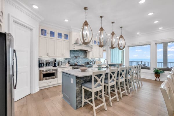 Modern kitchen with island seating and elegant pendant lights.