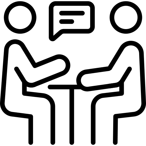 Two people sitting at a table having a conversation.